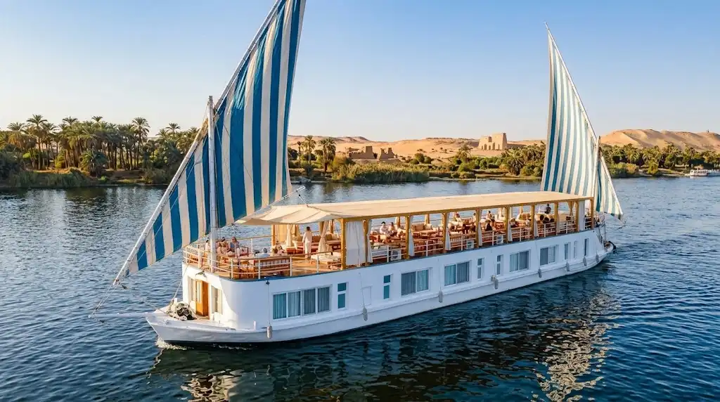Best Nile River Cruises in Egypt 2 Traditional dahabiya sailboat with striped sails cruising the Nile River